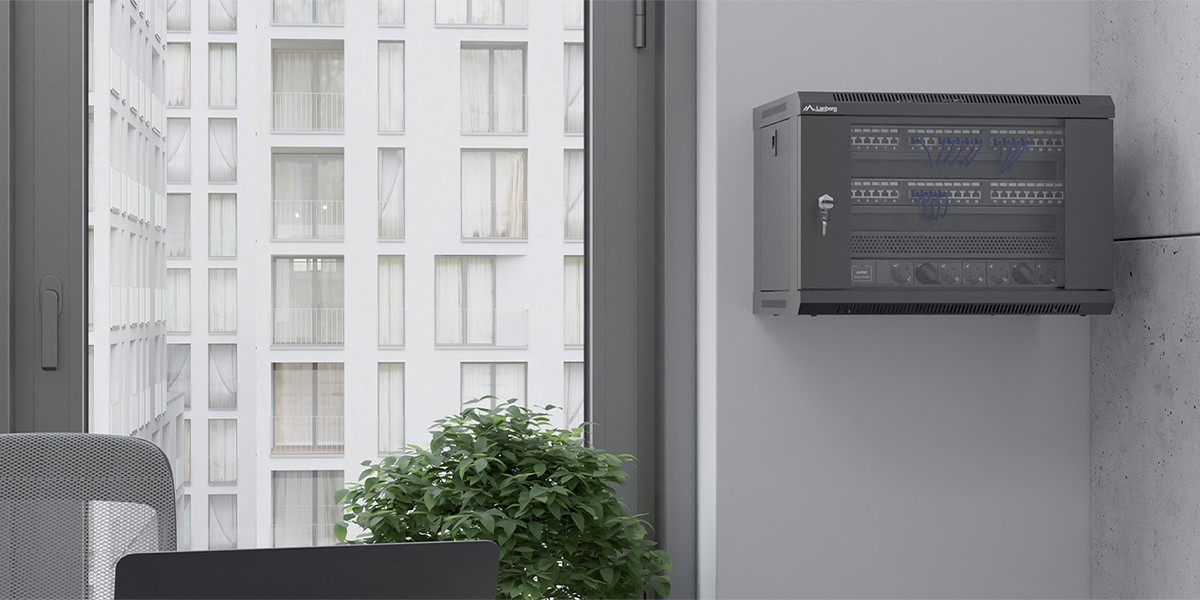 Hanging Lanberg rack cabinet on a wall of a small office